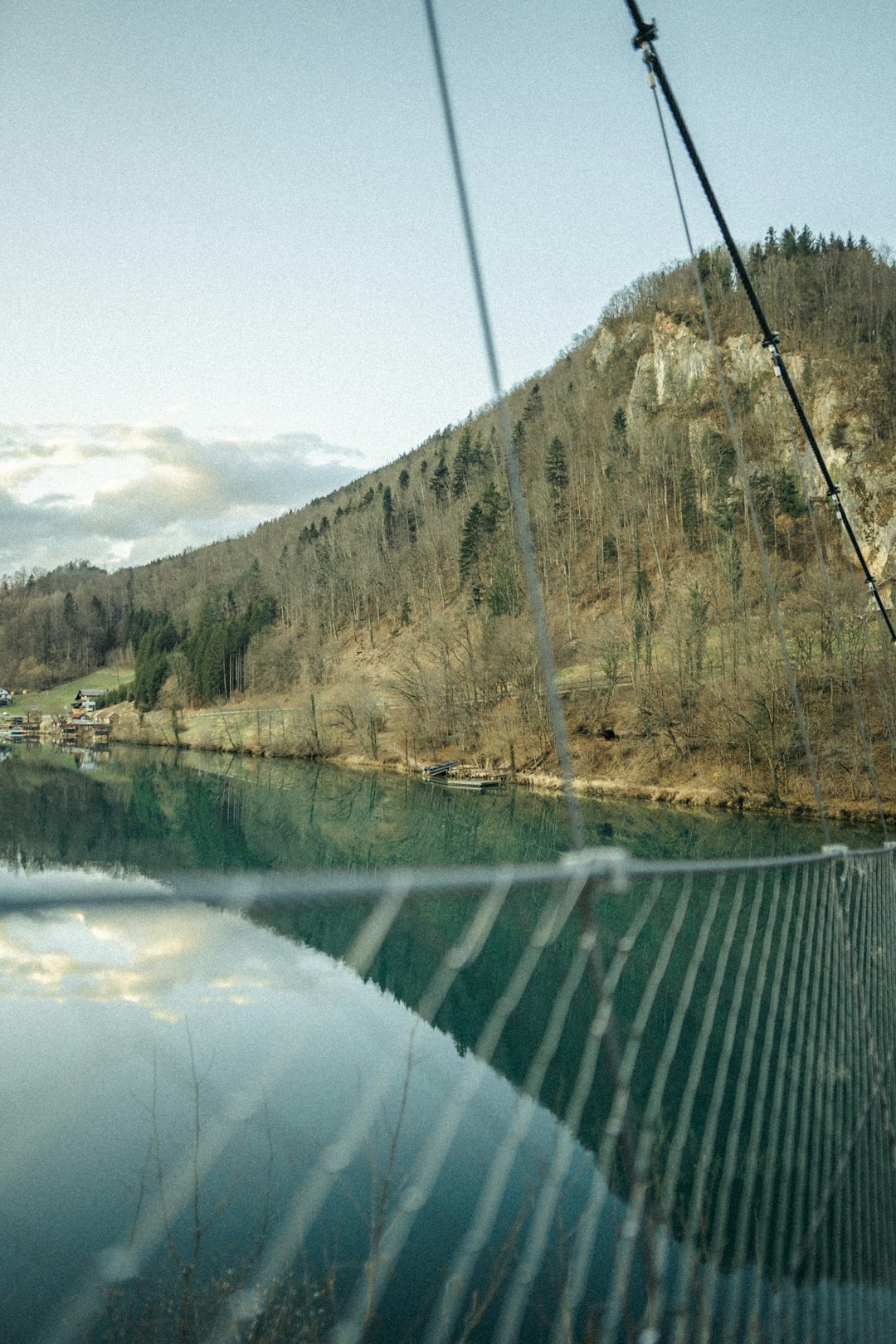 green and brown mountain beside body of water during daytime