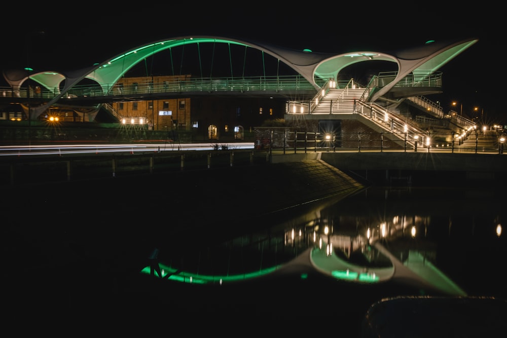 white bridge over body of water during night time