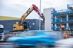 yellow and black heavy equipment near building