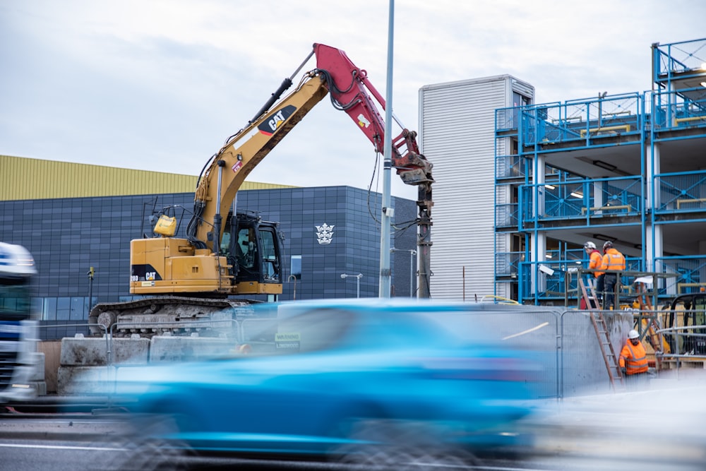 yellow and black heavy equipment near building