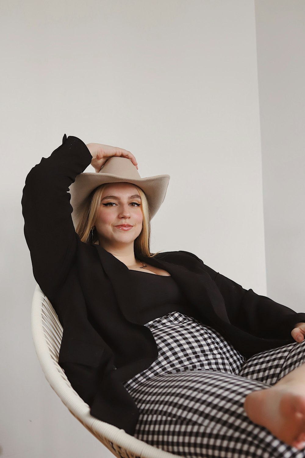 woman in black long sleeve shirt wearing brown fedora hat