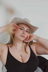 woman in black tank top wearing brown cowboy hat