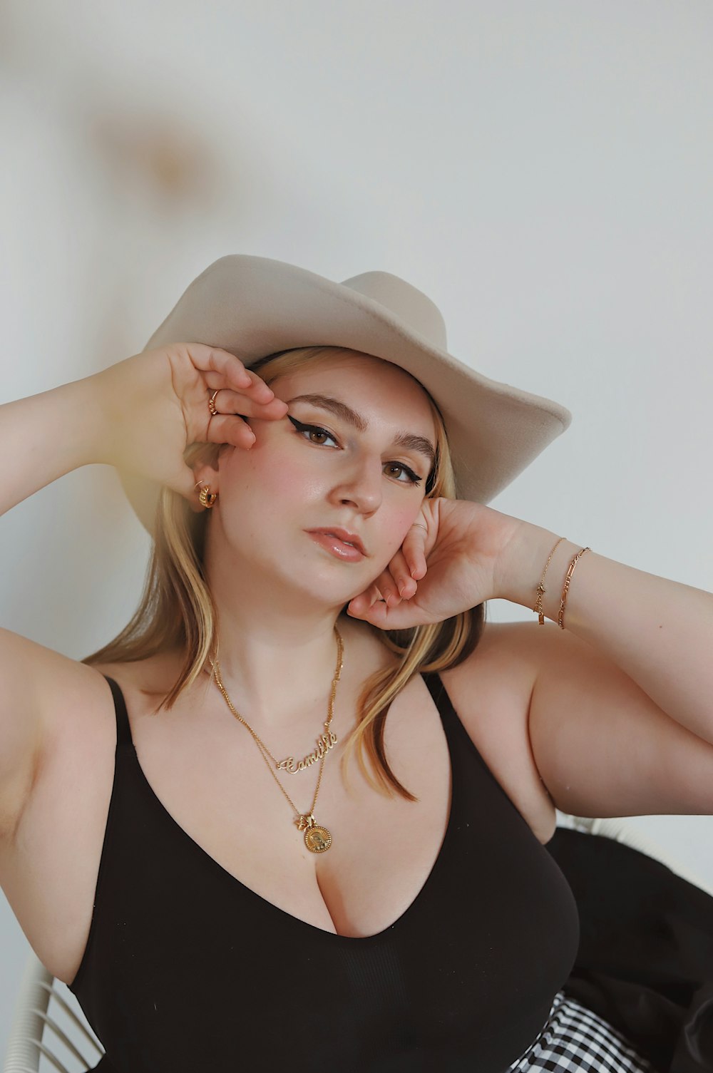 woman in black tank top wearing brown cowboy hat