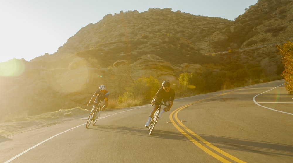 man in black jacket riding bicycle on road during daytime