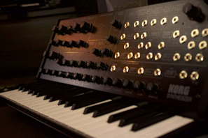 Microtonal tuning knobs and dials on an experimental synthesizer in a cozy studio corner