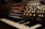 A synthesizer with a keyboard and a control panel full of knobs and input jacks, set in a dimly lit environment.