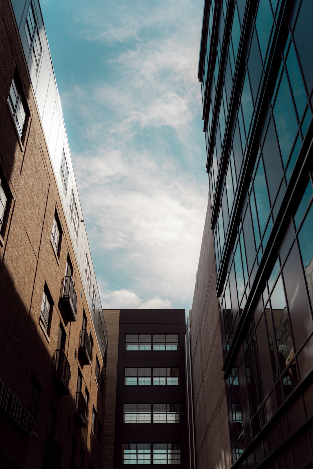 brown concrete building under white clouds during daytime