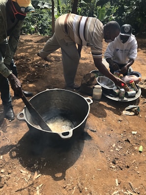 Community members engaging in a cooking demonstration outdoors