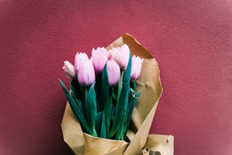 Delicate pastel tulips wrapped in natural kraft paper ready for delivery