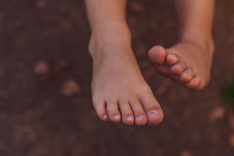 persons feet on black surface