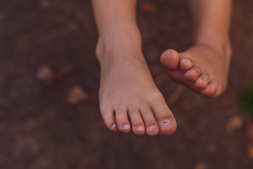 persons feet on black surface