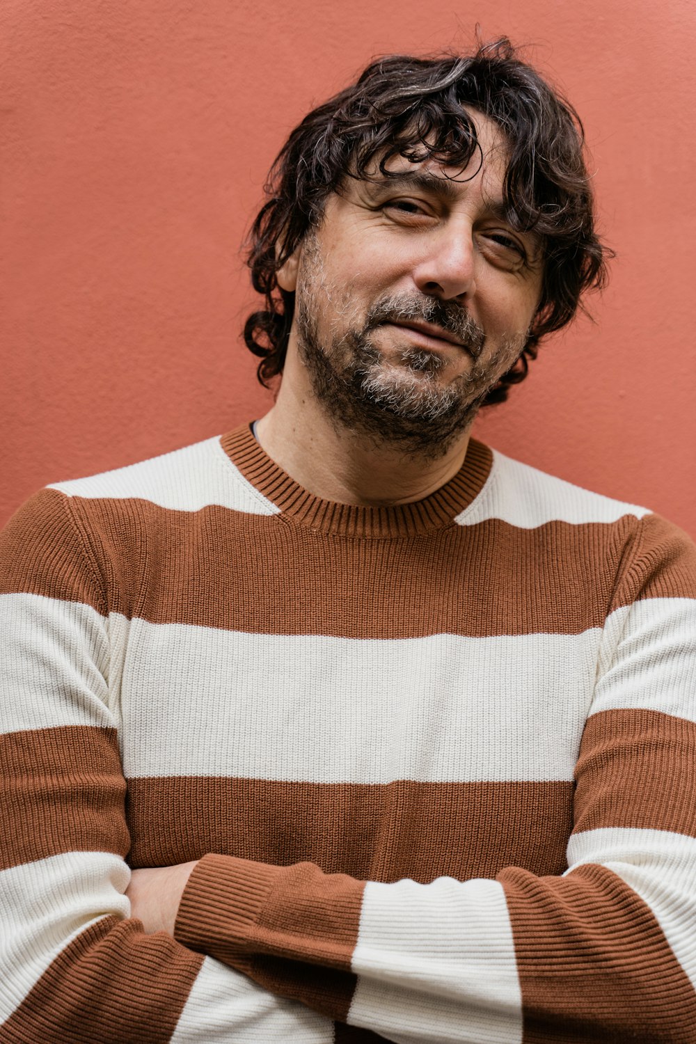 man in orange and white striped crew neck shirt