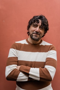 man in brown and white striped sweater