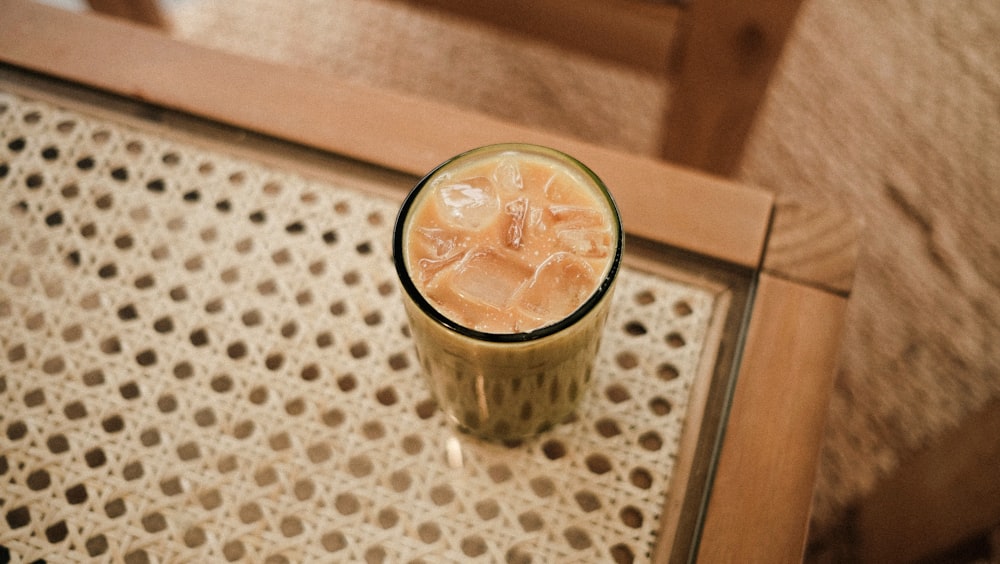 clear drinking glass with brown liquid and ice