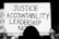A person is holding a protest sign with bold text reading 'JUSTICE ACCOUNTABILITY LEADERSHIP NOW' written on it. The sign also includes smaller text at the bottom stating 'MARCH4JUSTICE' and '#ENOUGHISENOUGH'. The image is in black and white, enhancing a serious and impactful tone.