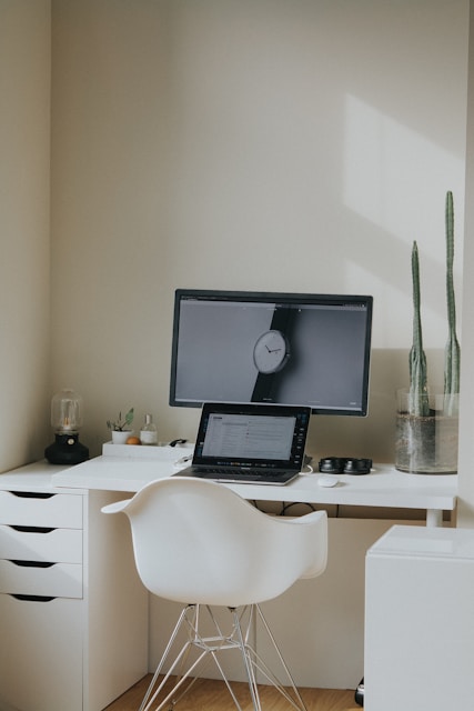 black laptop computer on white table