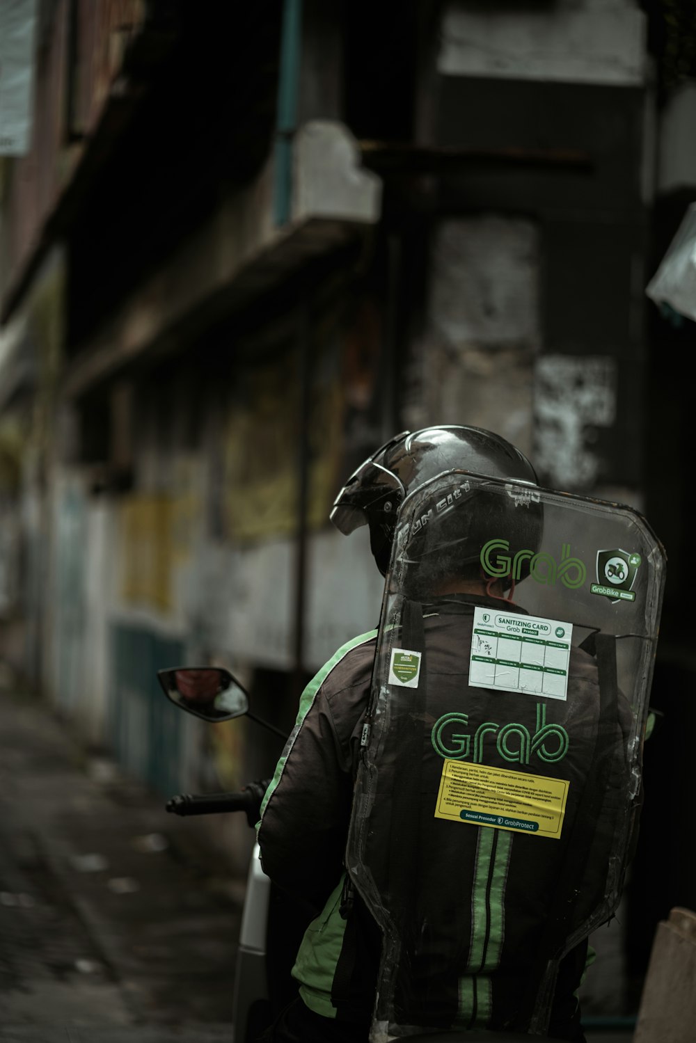 black and green backpack on black motorcycle