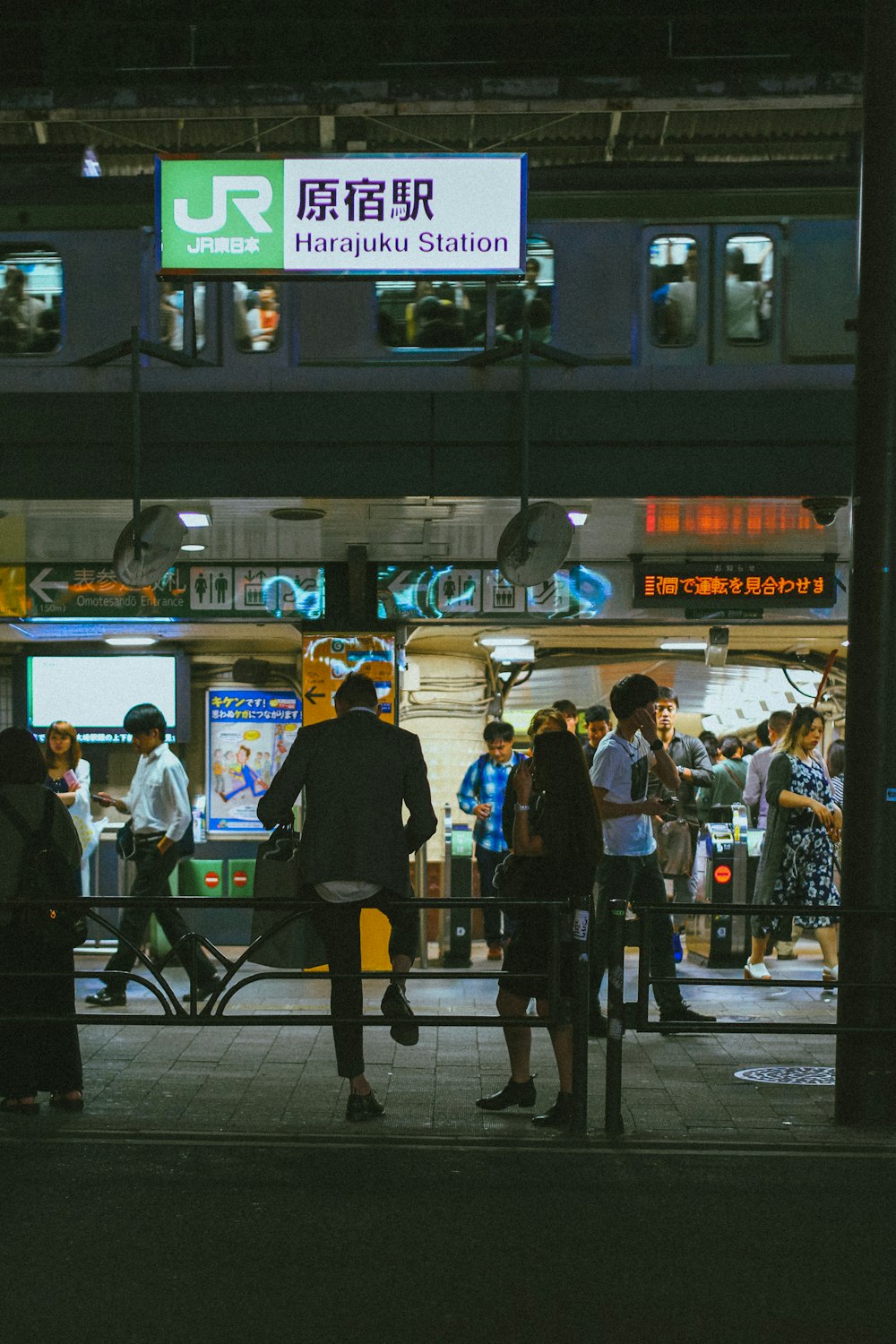 people walking on sidewalk during night time