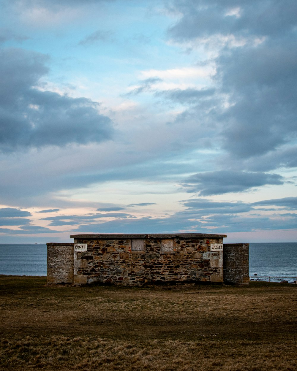 gray concrete building near body of water during daytime