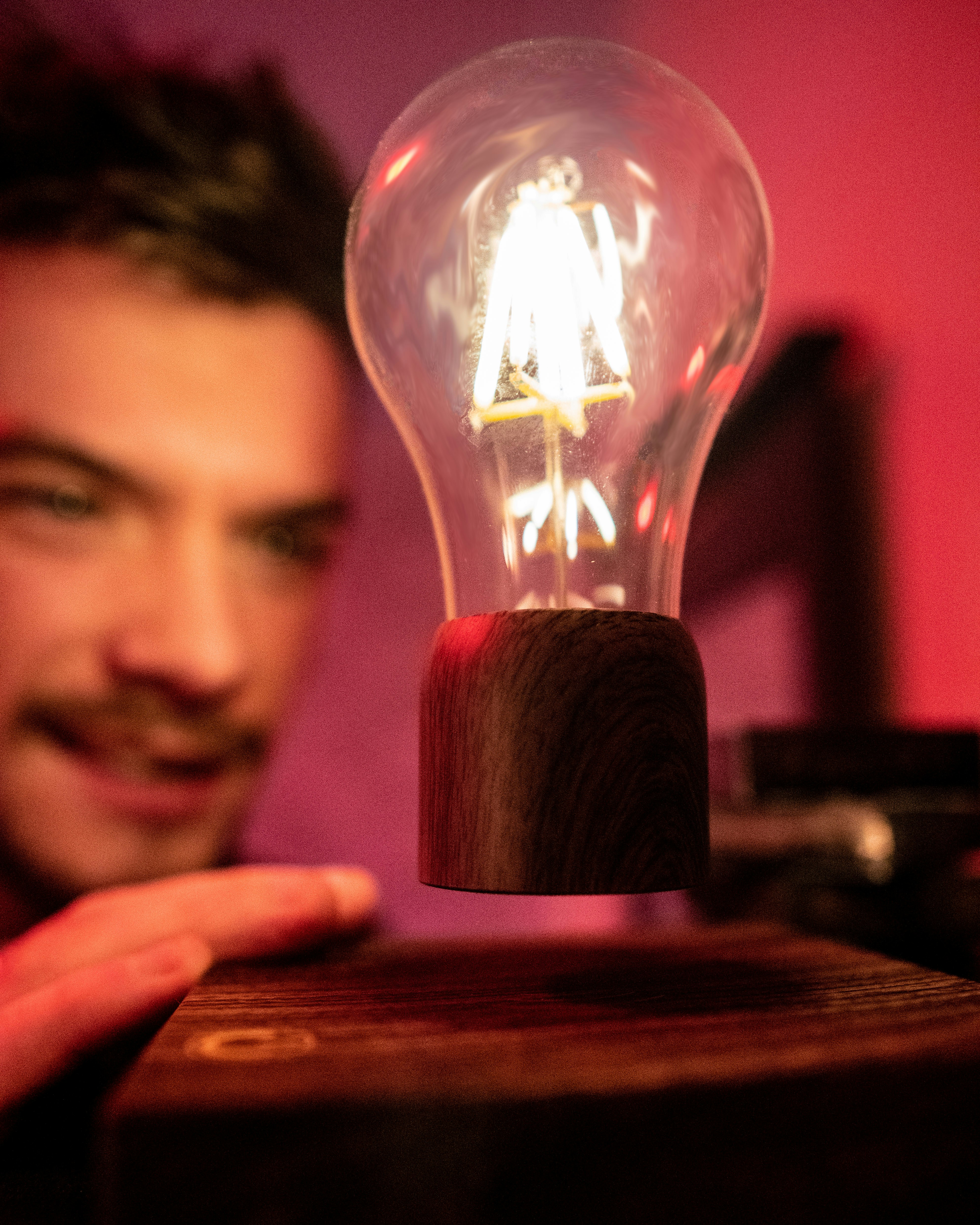man's face near a light bulb