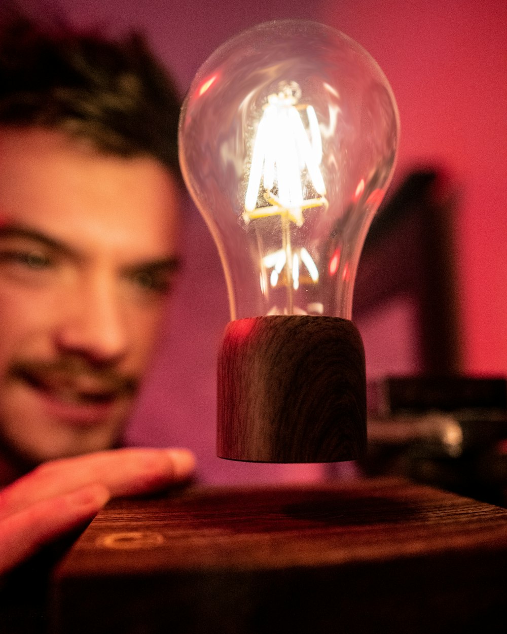 mans face near light bulb