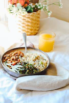 An inviting shot of a cozy breakfast setup featuring colorful stoneware dishes and a warm linen napkin.