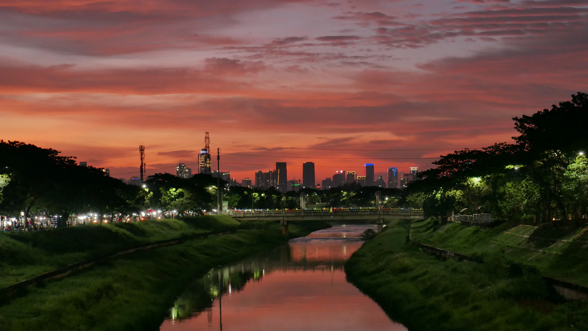 A scenic view of the iconic Dublin skyline at sunset, with the River Liffey reflecting the warm colors of the sky.