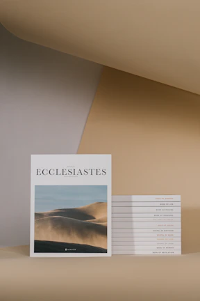 A minimalist arrangement of several brief Christian booklets fanned out on a clean white surface.