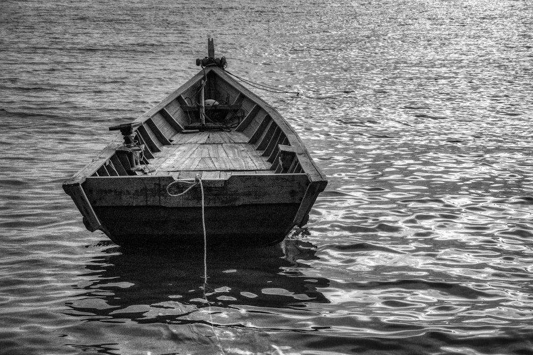grayscale photo of a boat on water