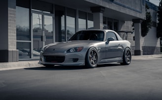Sporty car fitted with sleek silver rims parked outside the Agiste store.