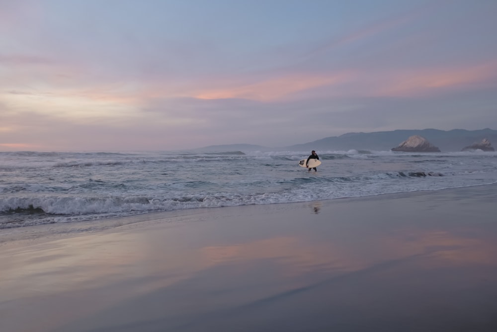 person surfing on sea waves during daytime