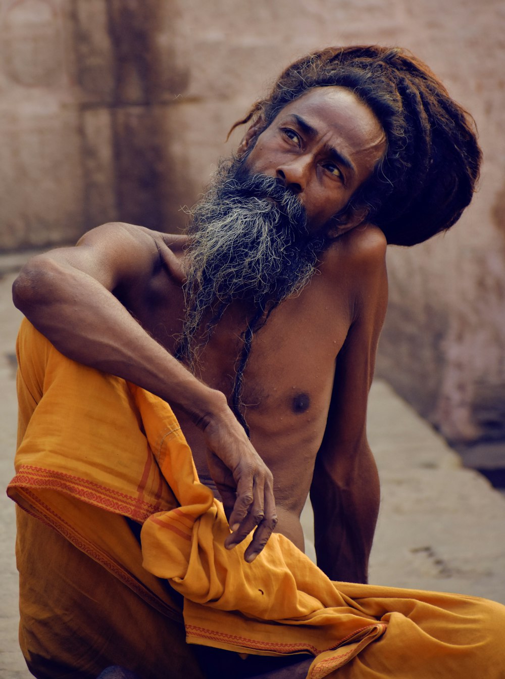 topless woman covering her body with yellow blanket