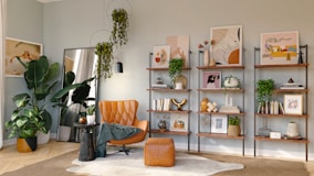 brown and black armchair beside white wooden shelf