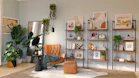brown and black armchair beside white wooden shelf
