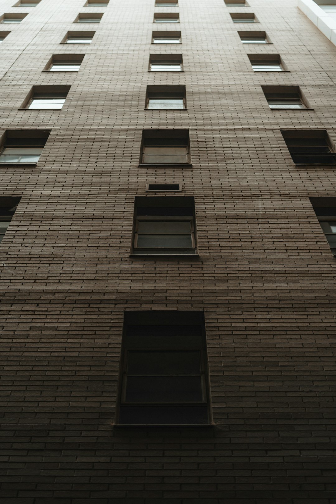 black window on brown concrete building