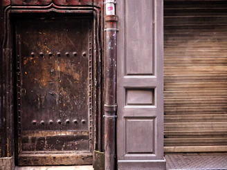 A robust industrial-style door with rivets and a matte black finish.