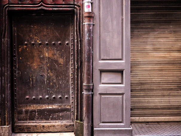 A robust industrial-style door with rivets and a matte black finish.