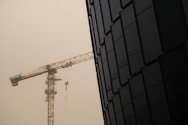 yellow crane near black building