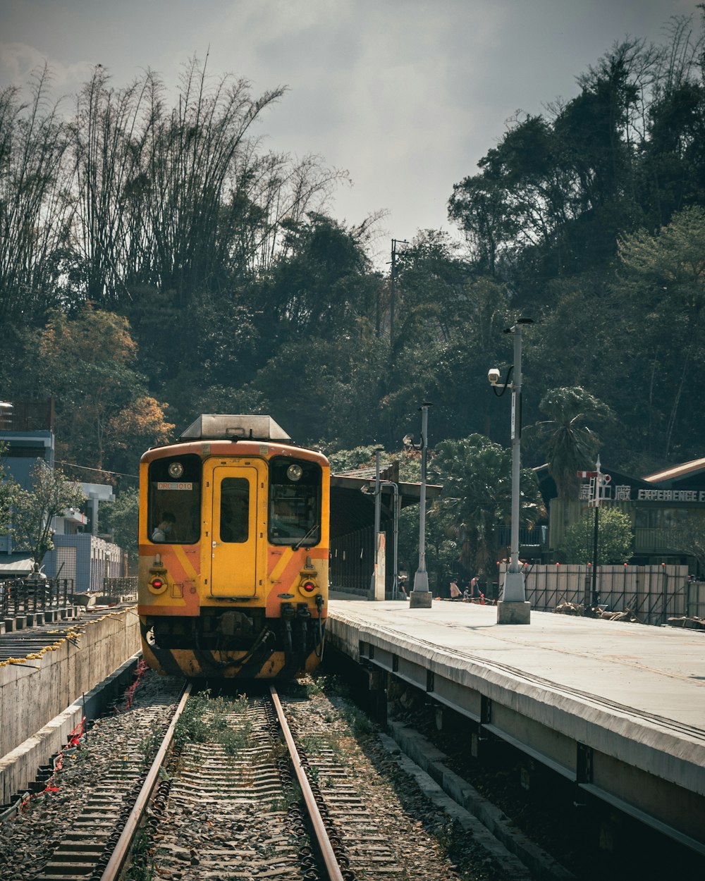 yellow train on rail during daytime