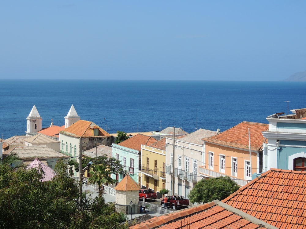 white and brown concrete houses near sea during daytime