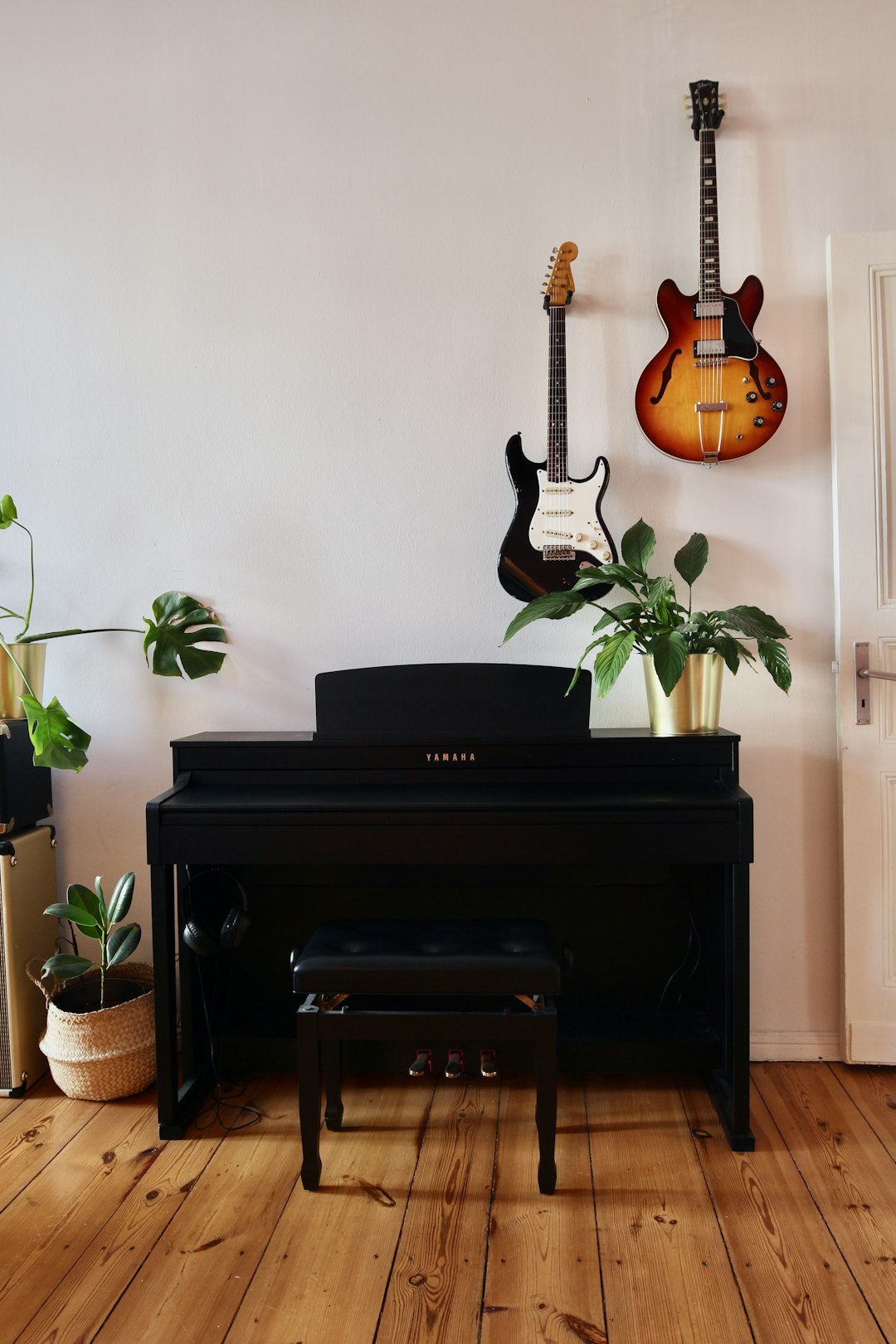 brown and black electric guitar on black guitar stand