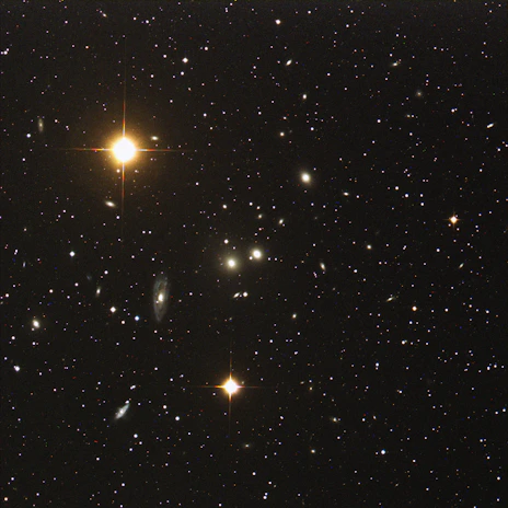 A telescope pointed towards a cluster of distant galaxies, capturing the vastness of the universe.