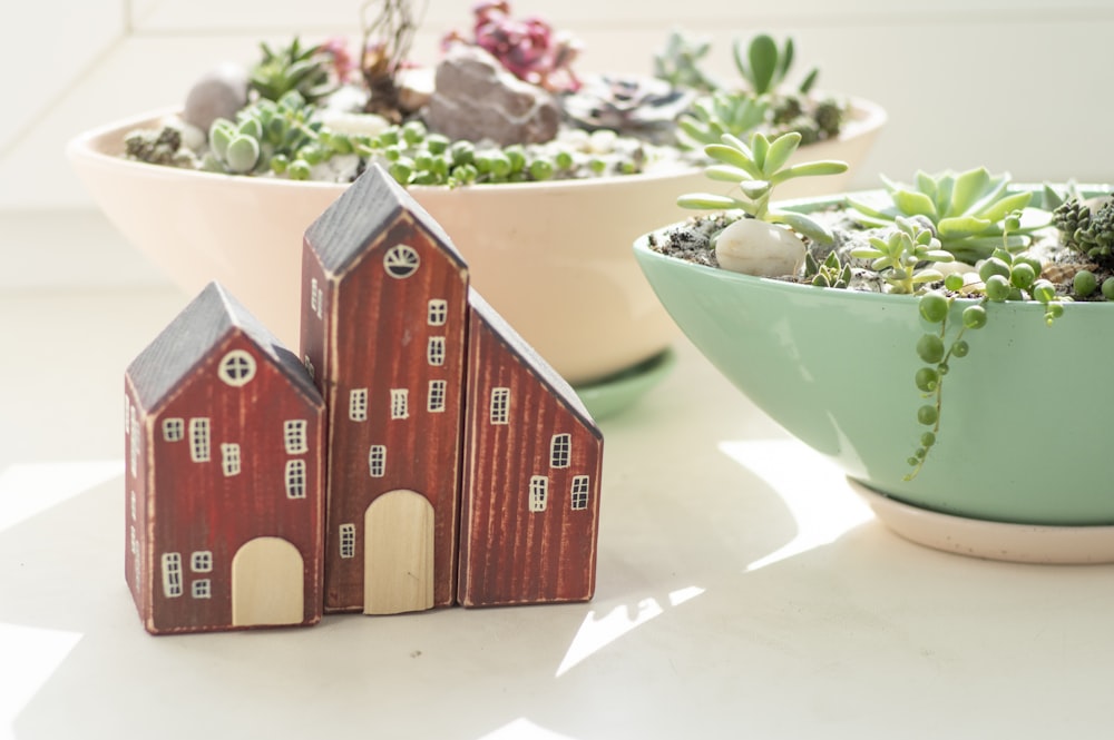 brown wooden house miniature on white table