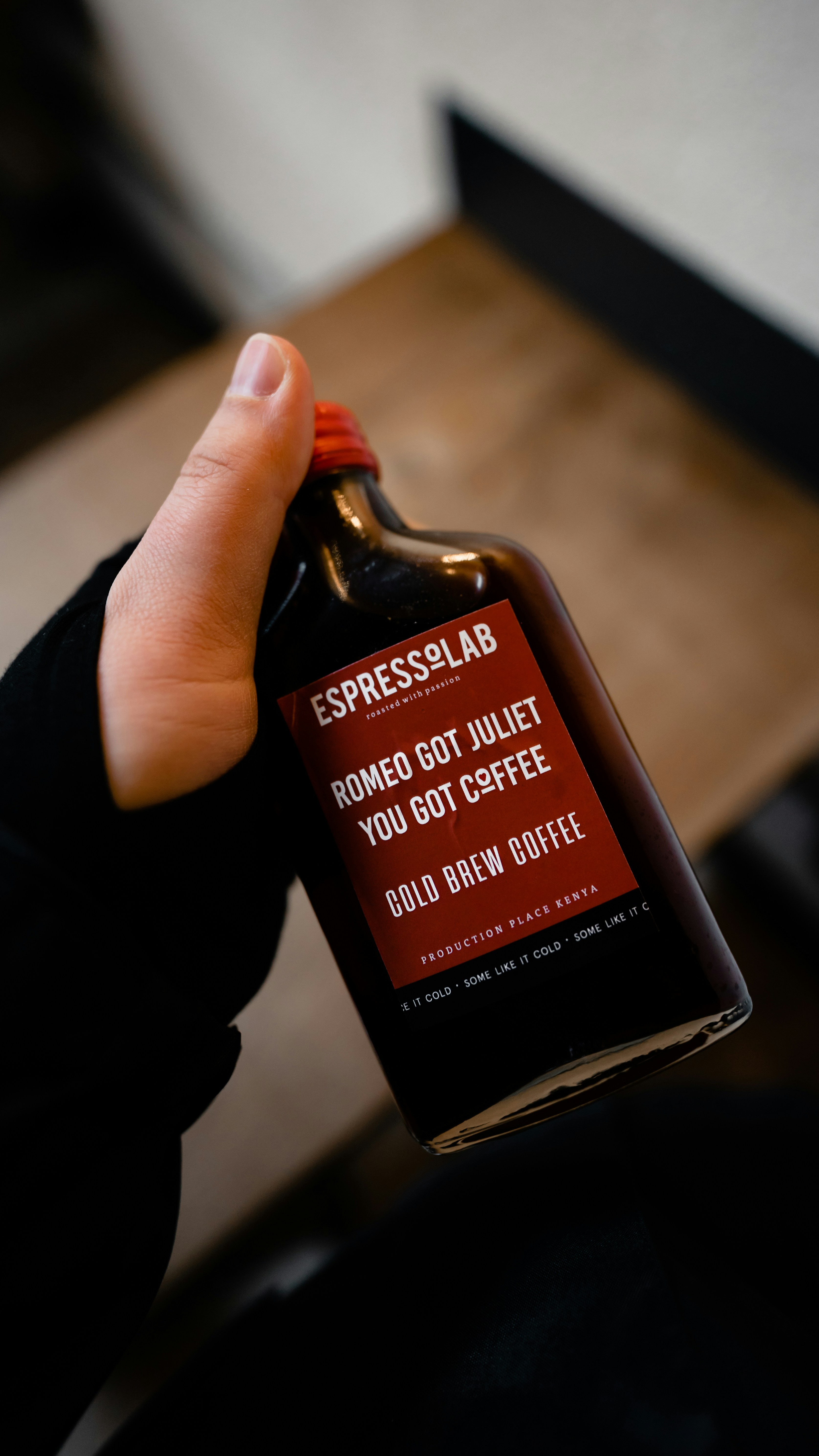 person holding black glass bottle