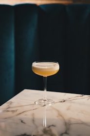 clear wine glass with yellow liquid