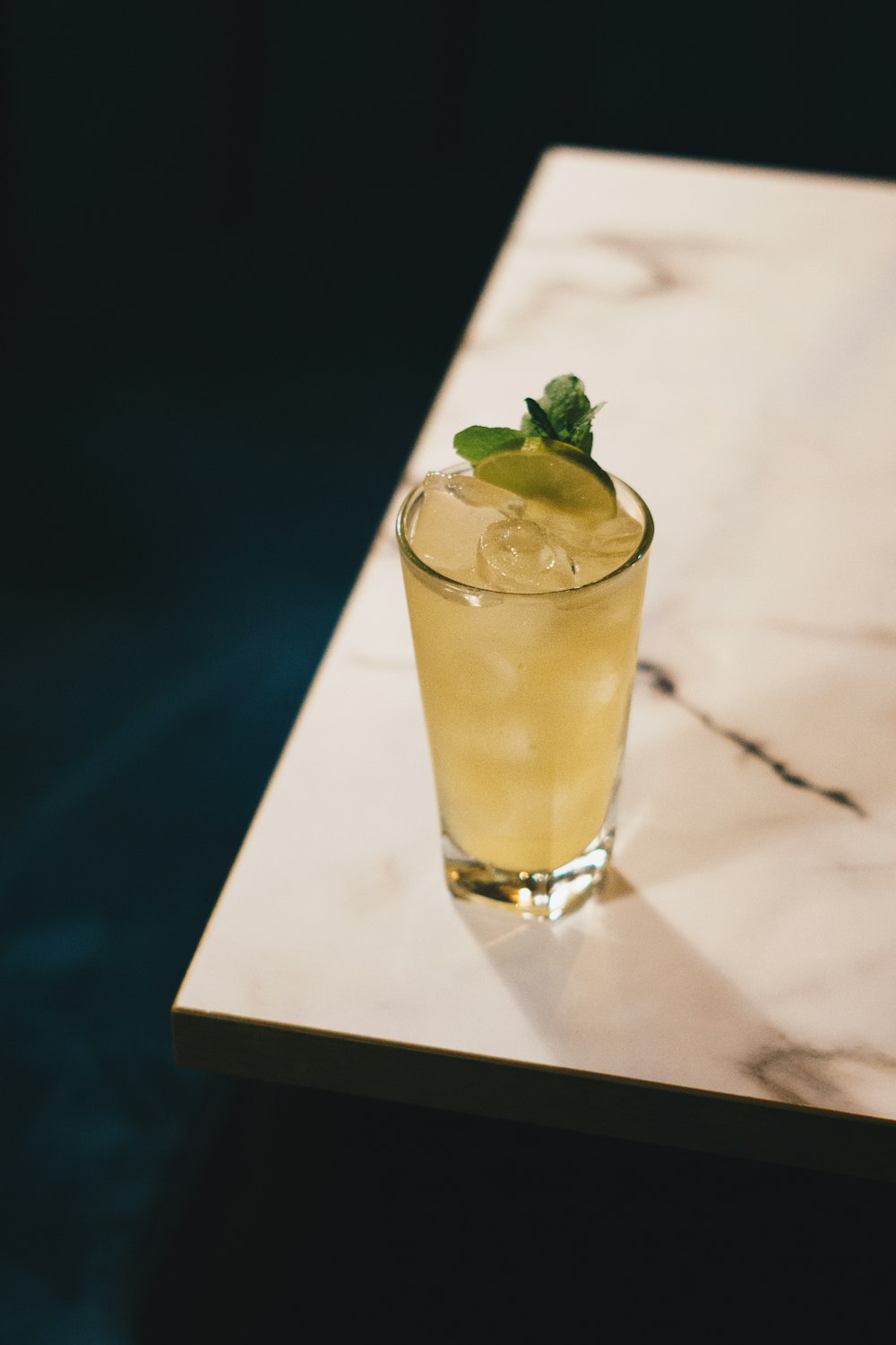 clear drinking glass with yellow liquid