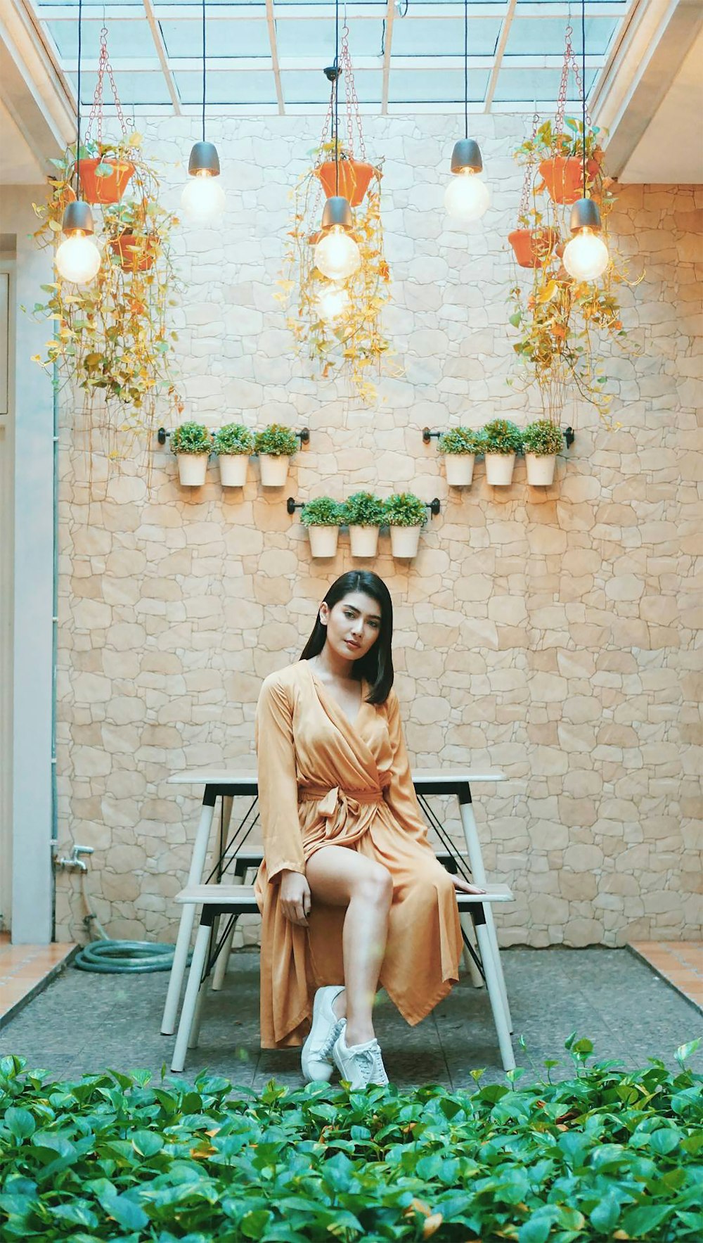 woman in beige long sleeve shirt sitting on white wooden armchair