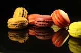 six red and yellow macaroons