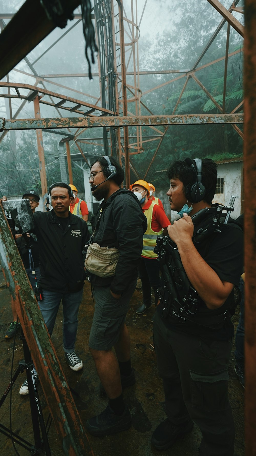 man in black t-shirt and gray pants holding black dslr camera