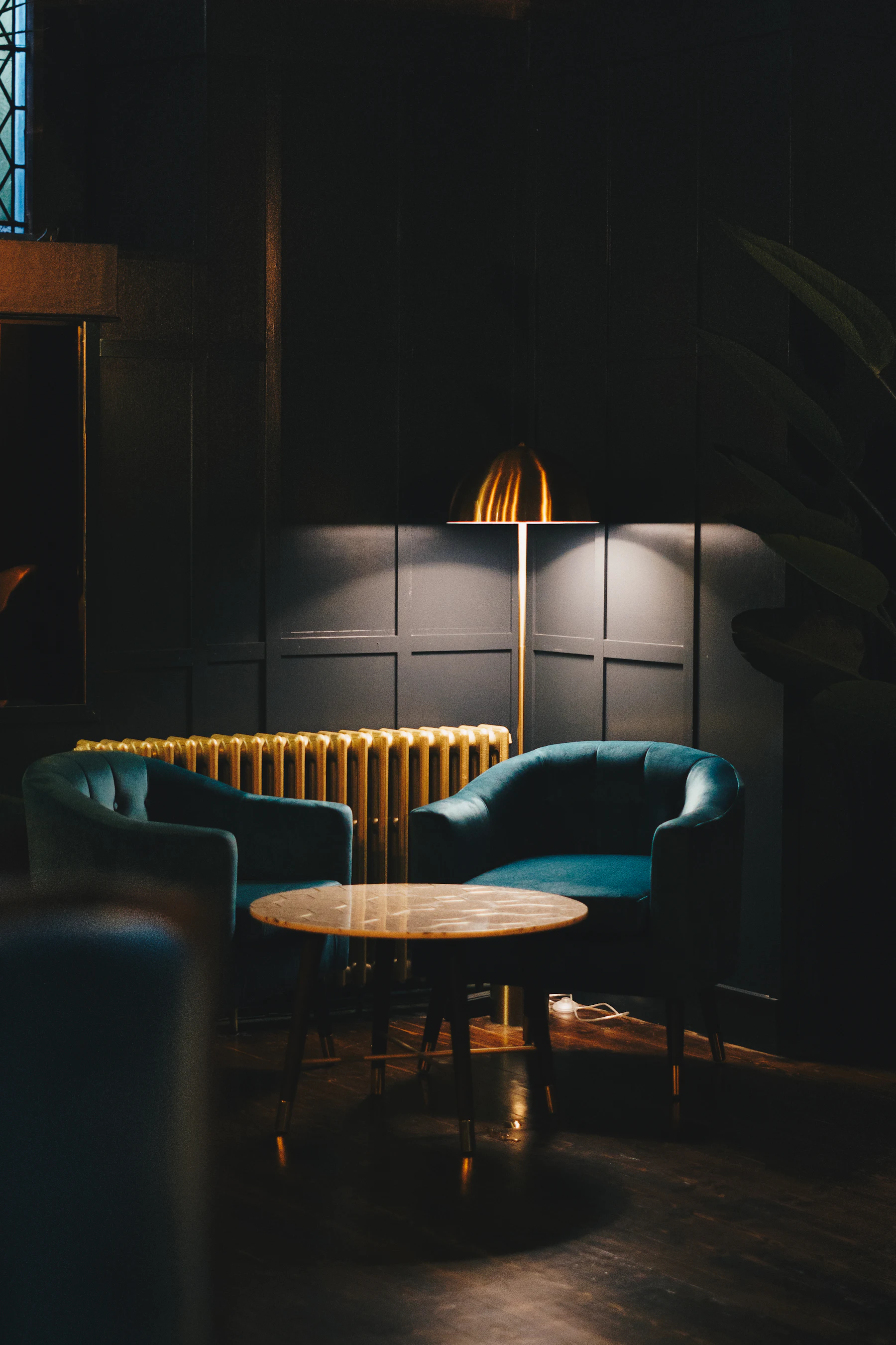 A low-lit bar room, glassware catching the light.
